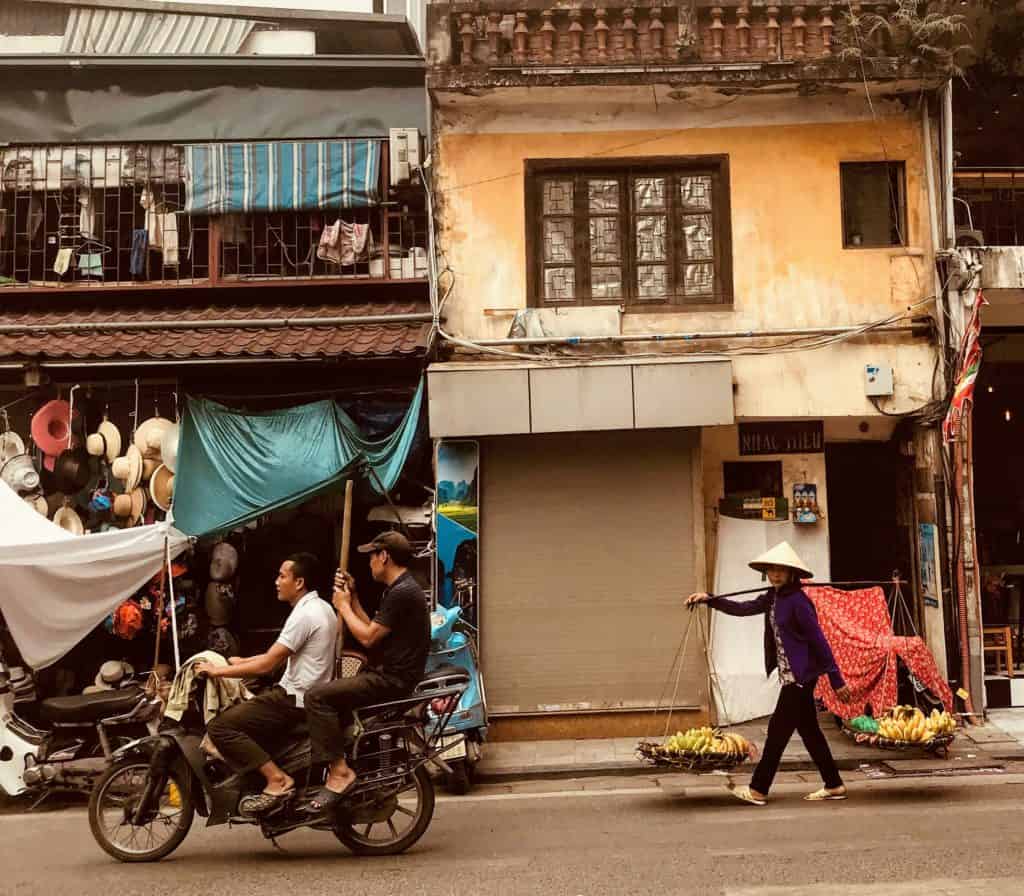 motorbike and street seller in Hanoi, Vietnam with kids