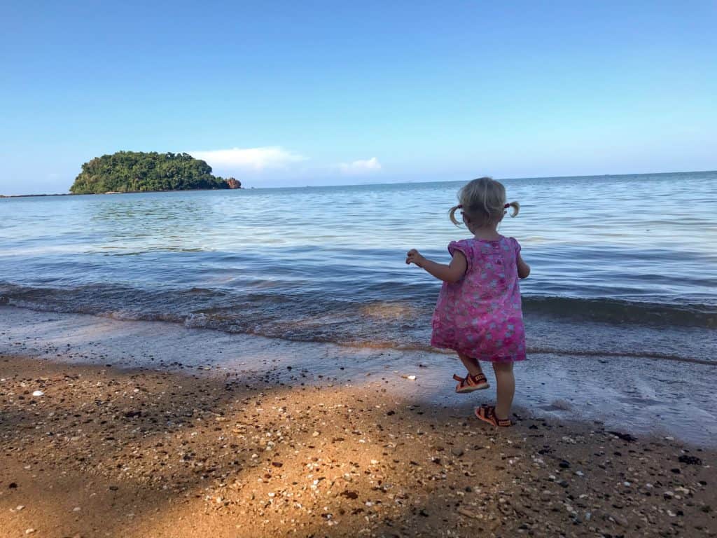 Young girl walking on the beach in Koh Libong with kids