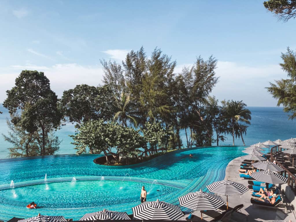swimming pool with sea behind at Pullman Phuket Arcadia, one of the best family resorts Phuket