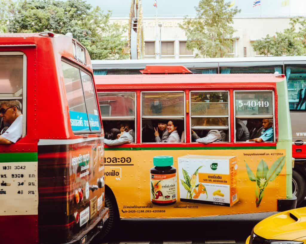 Yellow Bus from Phuket to Krabi with passengers looking out of the window