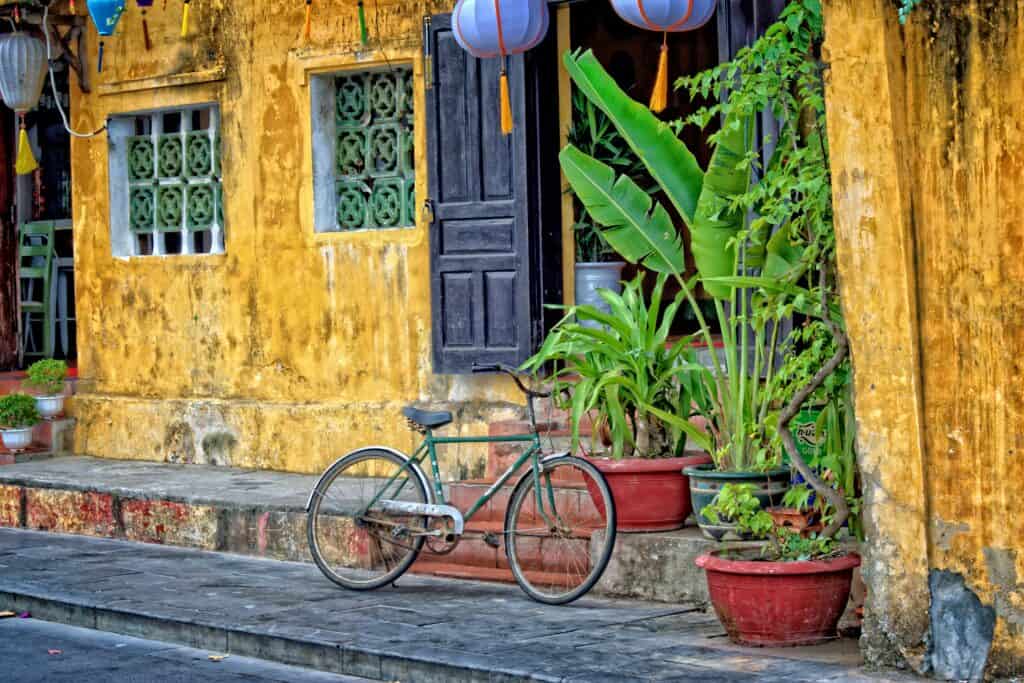 Bicycle against a yellow building in Hoi An, fianl stop on a 10 day Vietnam Itinerary