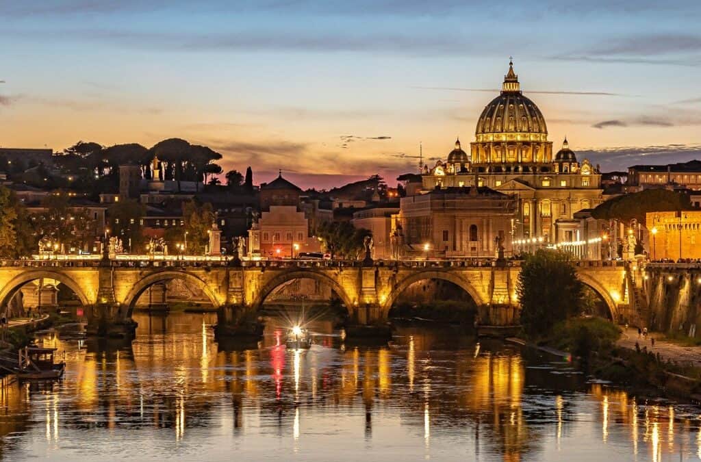 Night shot of bridge over a river with domed church. Rome on an Italy 10 day Itinerary