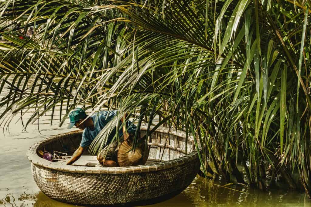 Where to Stay in Hoi An: Man fishing on the river n circular boat