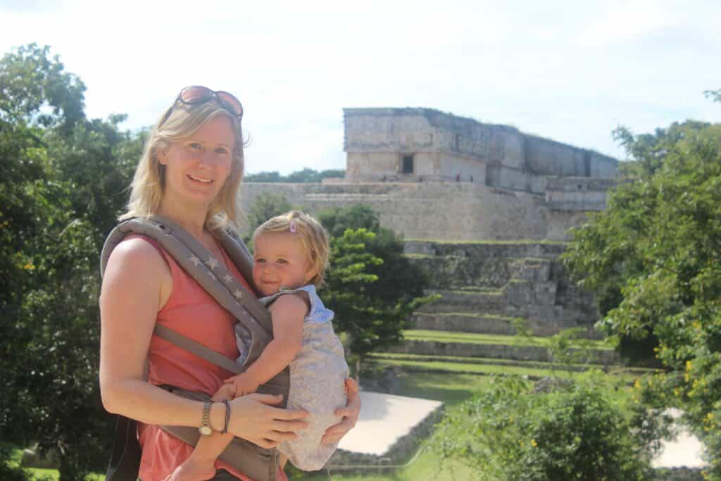 woman with baby in carrier infornt of Mayan ruins.Ergo vs Tula Carriers