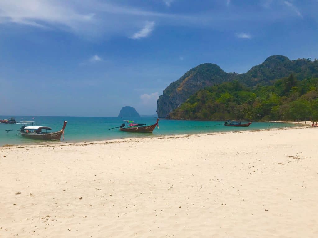 Longtail boat on sandy beach in Koh Mook