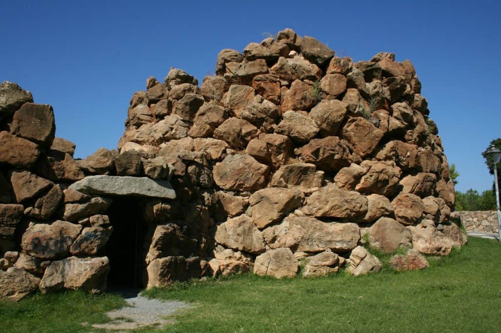 Image of ancient stone structure. Visiting a nuraghe is one of the best things to do in Alghero