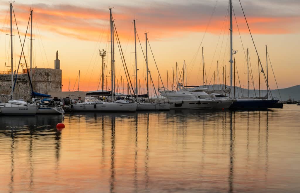 port of Alghero at sunset. An idea of where to go in Sardinia