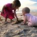 Thailand with a baby and toddler playing on the beach at sunset