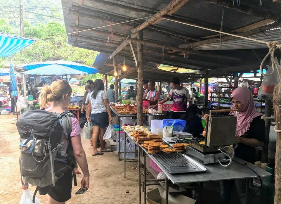 Choosing food in a market with a baby in Thailand