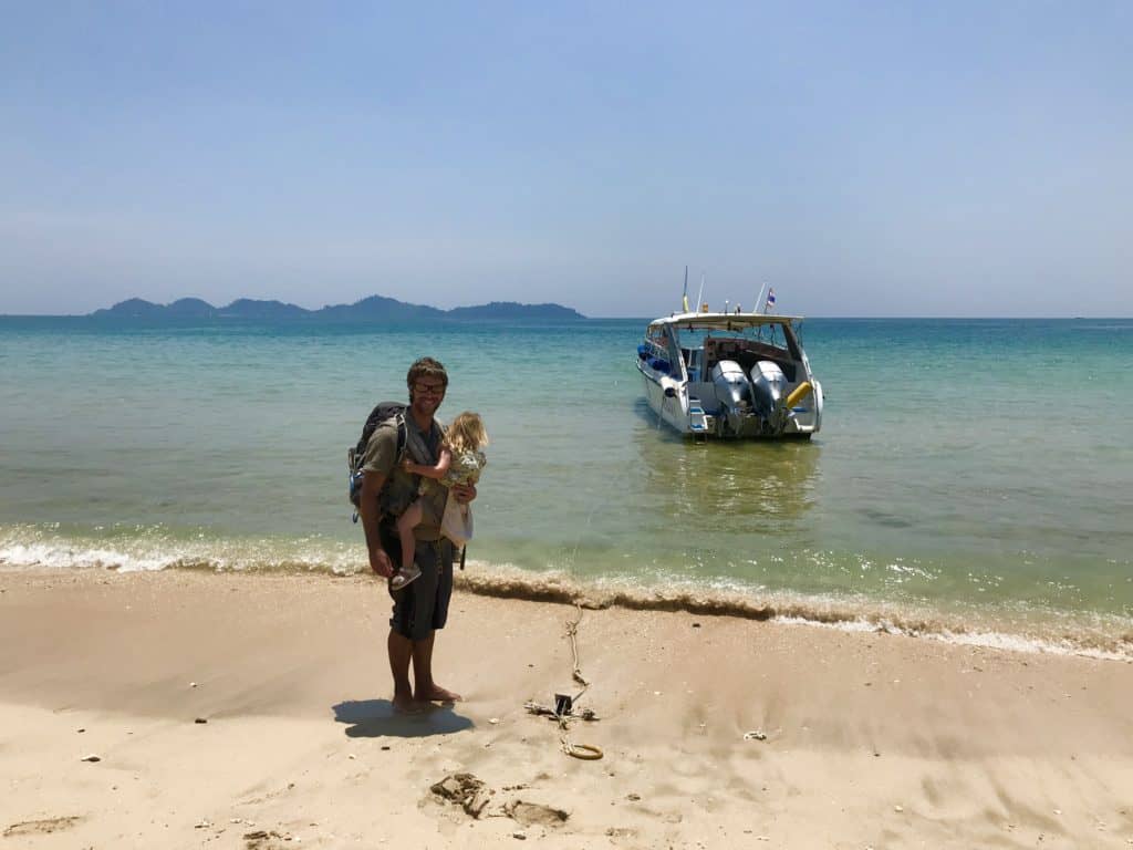 Arrival by boat on a beach in Koh Mook Thailand with a baby in a carrier