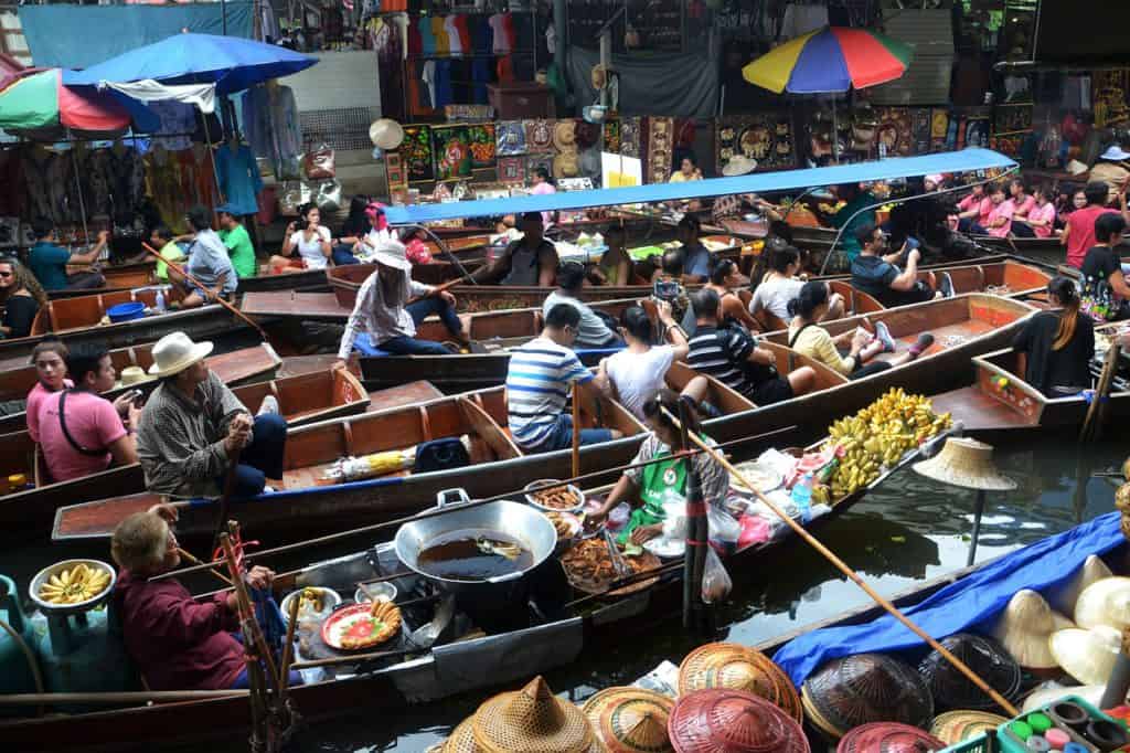 Bangkok 4 day itinerary :day 2 visit the floating markets. Image shows river crowded with wooden boats of floating market