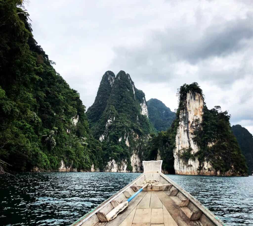 view of limestone cliffs from a boat on a Cheow Lan Lake Tour